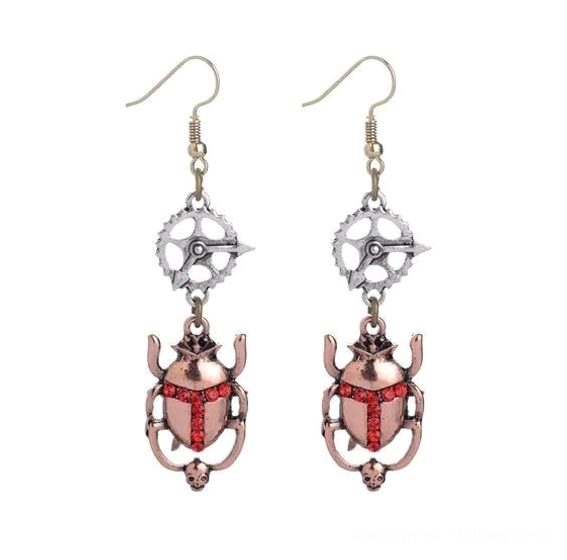 Antique copper steampunk scarab beetle earrings with red rhinestone decor, product flat photography