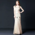 Steampunk sequin mermaid gown in apricot with sheer cap sleeves, V-neckline, and intricate beaded embellishments - front full-body view of 1920s-inspired evening dress