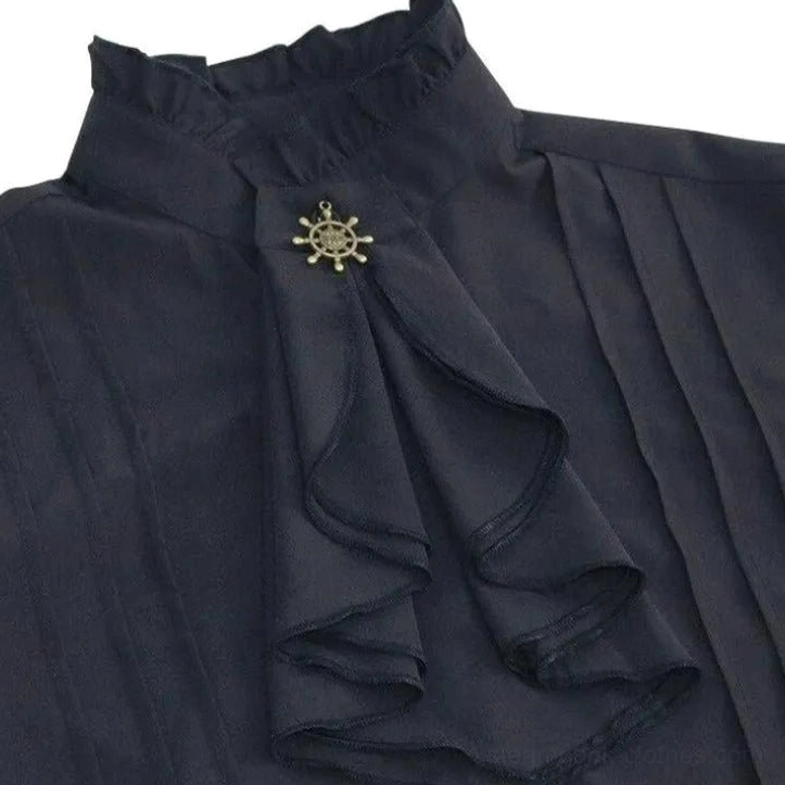 Close-up detail of black steampunk shirt ruffled stand collar with nautical metal brooch, layered ruffled front placket, and fabric pintuck construction