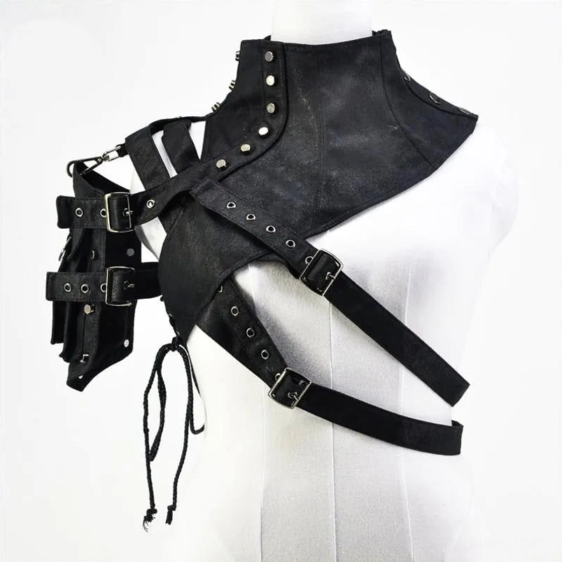 Female mannequin displaying black asymmetrical steampunk shoulder armor with crisscross straps, metal hardware, drawstring details, and functional utility pouches, front view