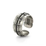 Vintage 925 sterling silver steampunk ring with rivet accents and dark inlays, three-quarter view showing S925 hallmark stamp inside, plain white background