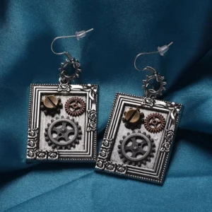 Steampunk silver square gear drop earrings with floral frame design, screw detail and cog decorations on dark teal background