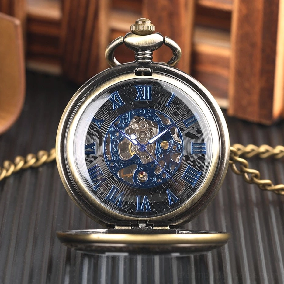 Skeleton steampunk pocket watch front view displaying blue accent gears, flip-up protective cover, and hanging ring on dark wooden background