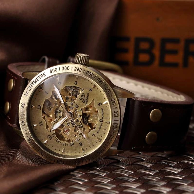 Steampunk skeleton mechanical watch with bronze dial and hollowed gear movement - top view showing transparent face and intricate mechanical details