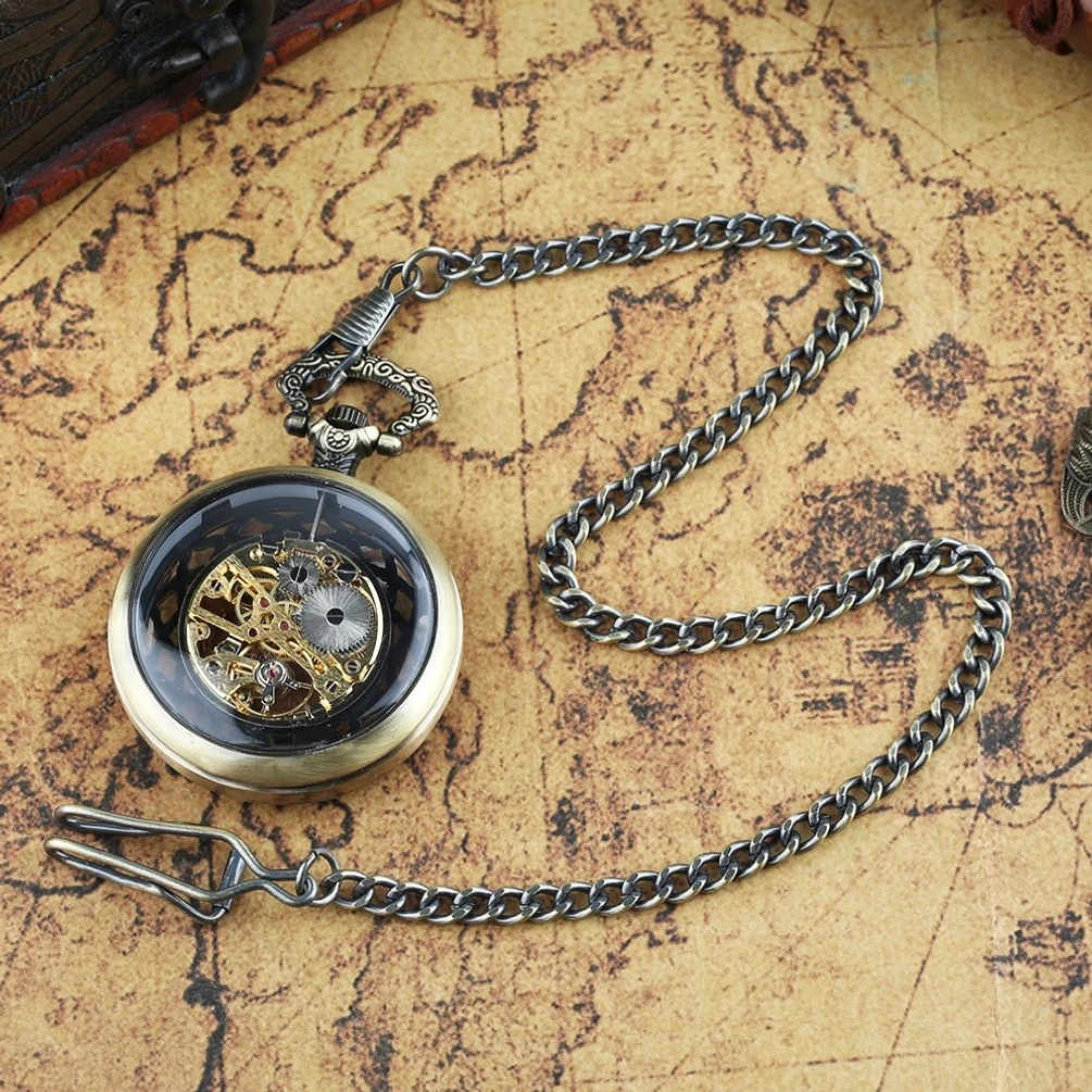 Half-covered skeleton steampunk pocket watch with polished bronze case and black dial base showing exposed gear movement, photographed from side overhead angle on vintage map background