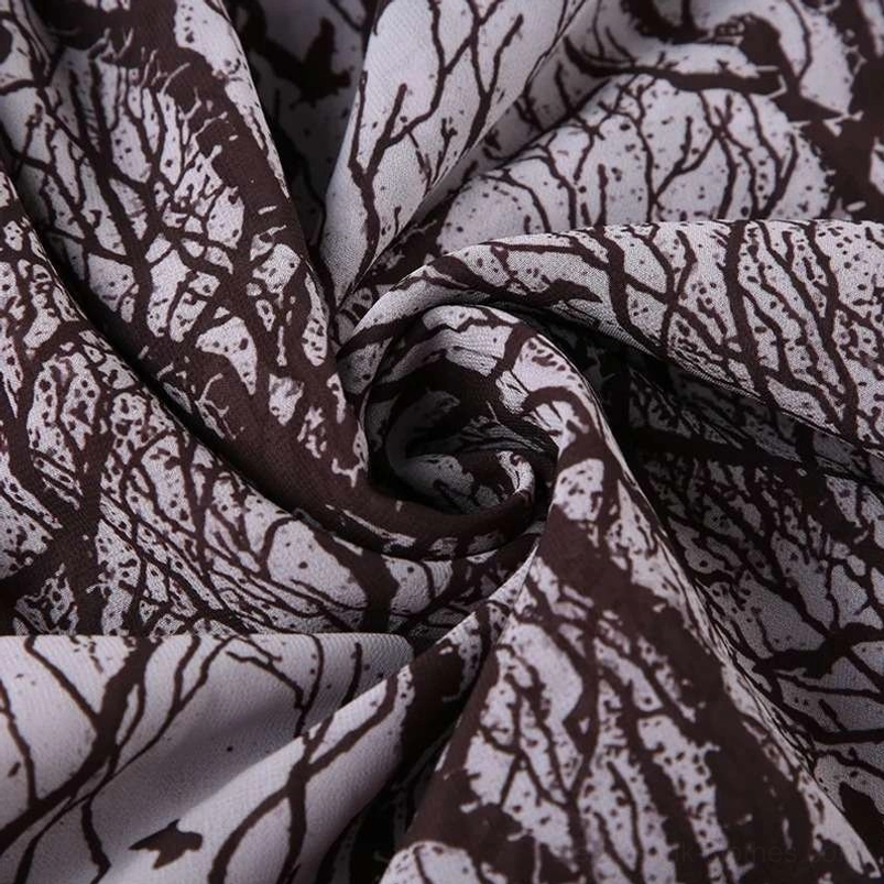 Close-up fabric texture of steampunk skirt showing matte woven finish with bare branch print and soft drape quality