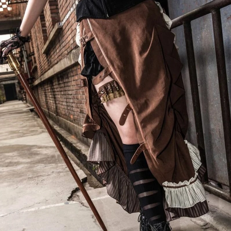 Close-up detail of brown ruched steampunk skirt showing suede texture, garter strap detail, and striped thigh-high socks pairing, low side angle