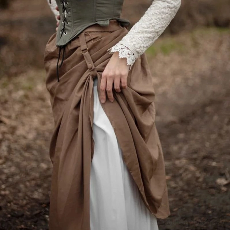 Close-up waist detail of high-waisted steampunk skirt showing front draped design and adjustable ruching mechanism with button and strap closure