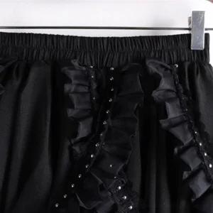 Close-up detail of steampunk skirt waistband with elasticated design and ornate studded ruffled lace trim embellishment