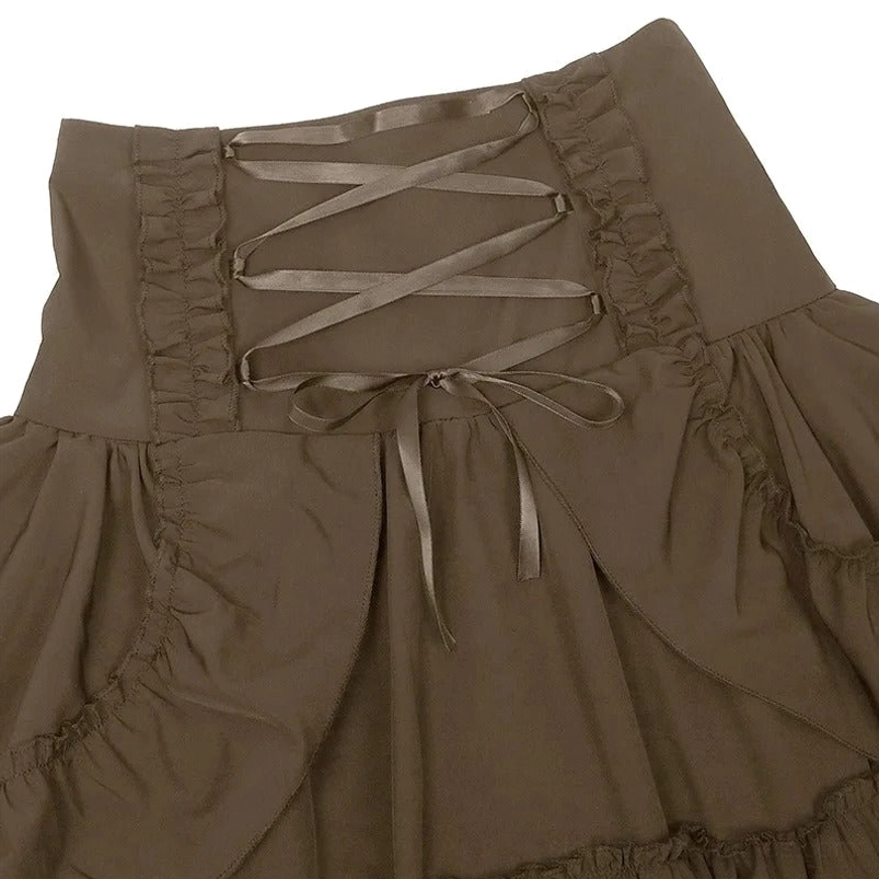 Close-up detail of steampunk skirt waist showing crisscross satin ribbon ties, lace-up corset construction, and ruffled trim
