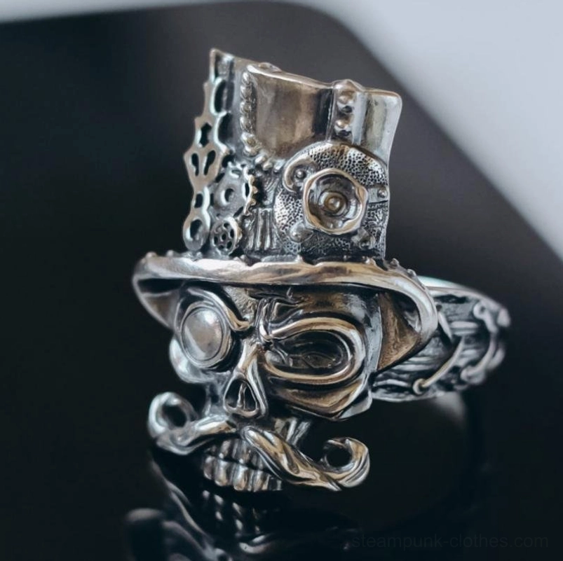 Steampunk skull gentleman ring front view with ornate gear top hat and monocle on dark reflective surface