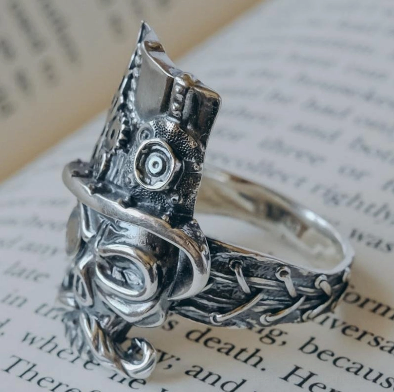 Steampunk mechanical skull ring side profile showing textured engraved band and gear decorations