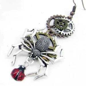 Single steampunk spider earring close-up detail showing antique mixed metal finish and ladybug charm