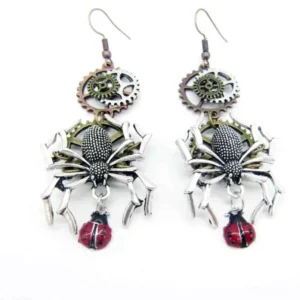 Paired steampunk spider drop earrings with bronze gears, silver spiders, and red spotted ladybug pendants on white background