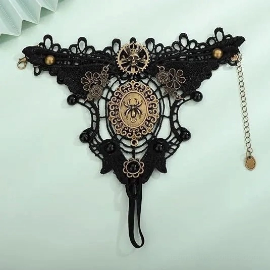 steampunk spider gloves flat lay overhead view showing elastic wrist strap and vintage bronze decorative details
