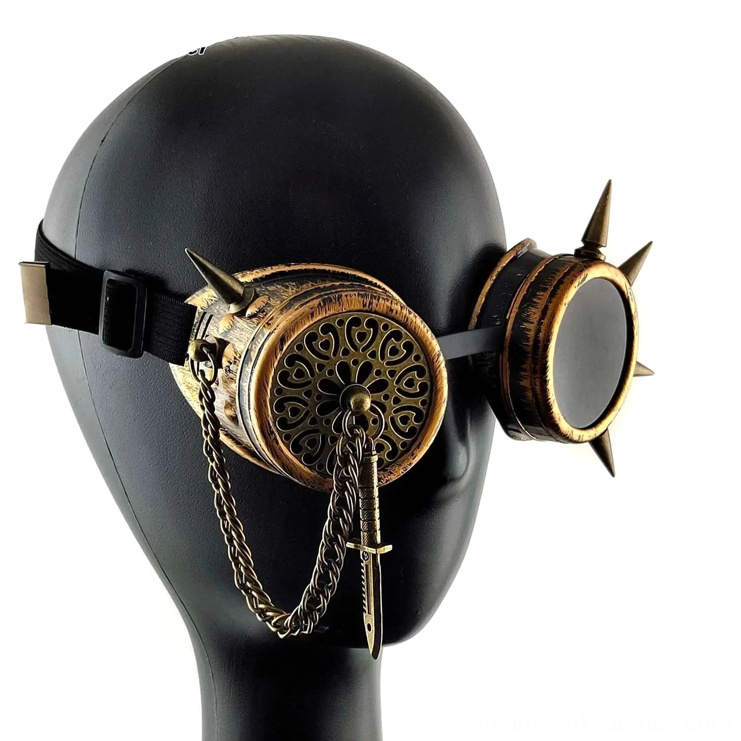 Steampunk spike goggles worn on mannequin head, front three-quarter view displaying adjustable black elastic strap and complete spike embellishments