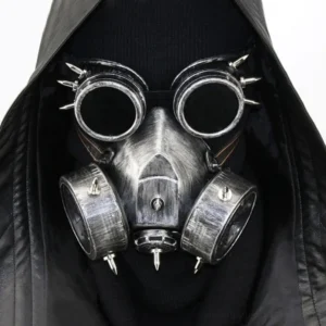 Steampunk spiked gas mask with welding goggles front view on model wearing black hooded leather coat - silver weathered metal finish with dual filter canisters and spike decorations