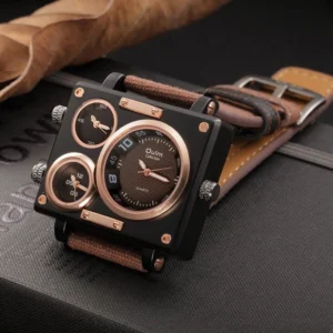 Steampunk square multi-dial wristwatch with bronze and black color scheme, displayed on dark leather desk with canvas-leather strap visible, top-down oblique angle showing intricate dial faces