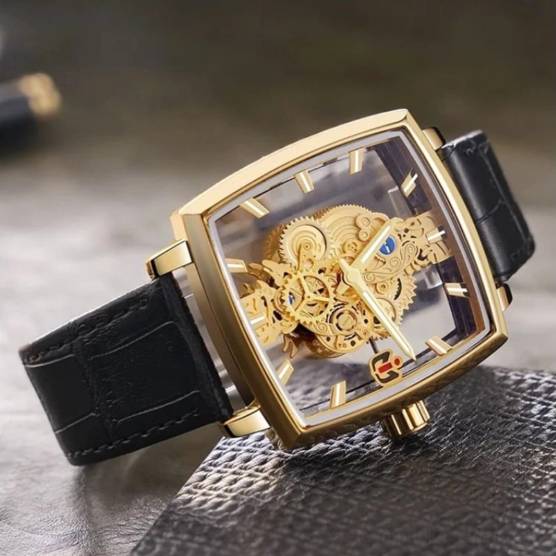 Square steampunk timepiece high-angle side view featuring gold hardware, transparent watch cover and intricate gear design mechanism