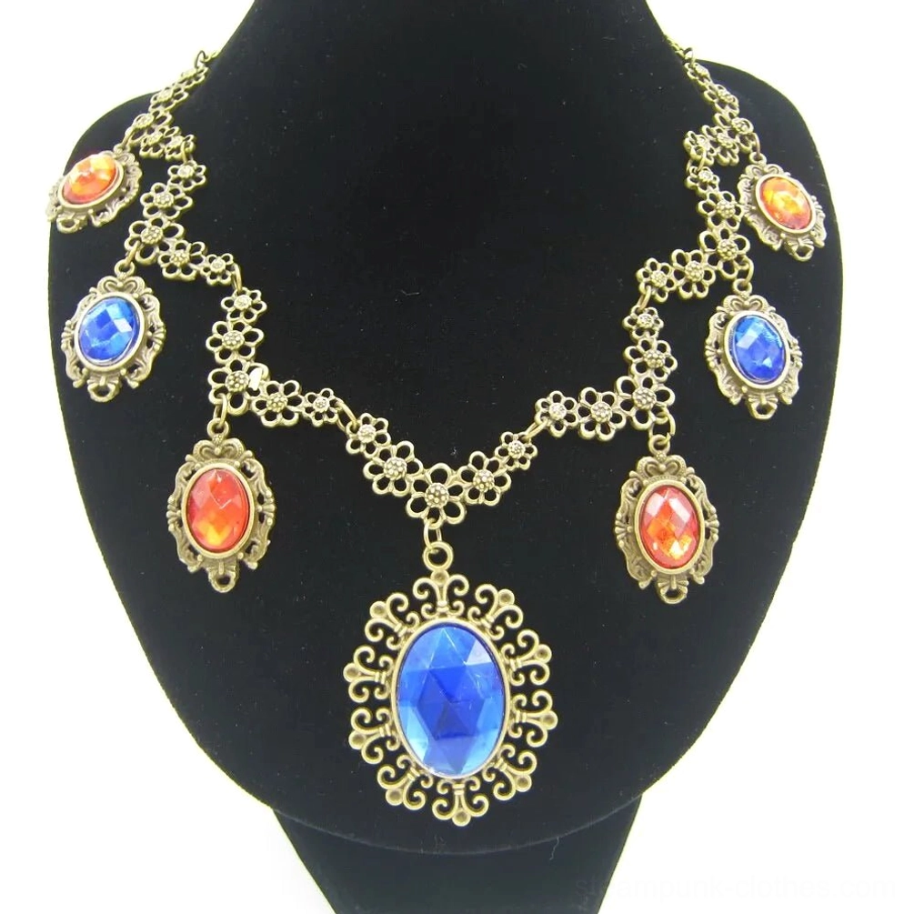 Steampunk statement necklace front view on mannequin featuring antiqued bronze filigree setting with large blue oval pendant and mixed orange-red faceted gemstones