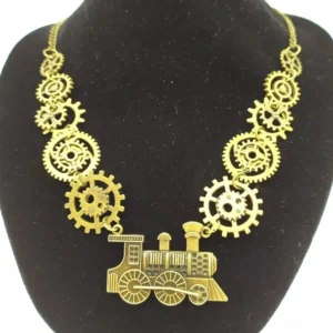 Gold-tone steampunk steam train necklace with gear chain links displayed on black velvet jewelry mannequin, showcasing intricate locomotive pendant detail and industrial chain design