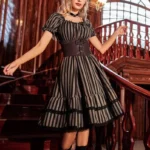 Steampunk striped midi dress with smocked waist, featuring black and white vertical stripes, square neckline, lace trim details, and Victorian-inspired corset design - front three-quarter view on model