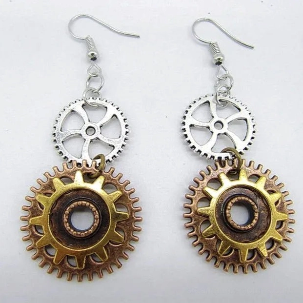 Steampunk mechanical sun gear dangle earrings with layered bronze silver and gold metal cogs on white background