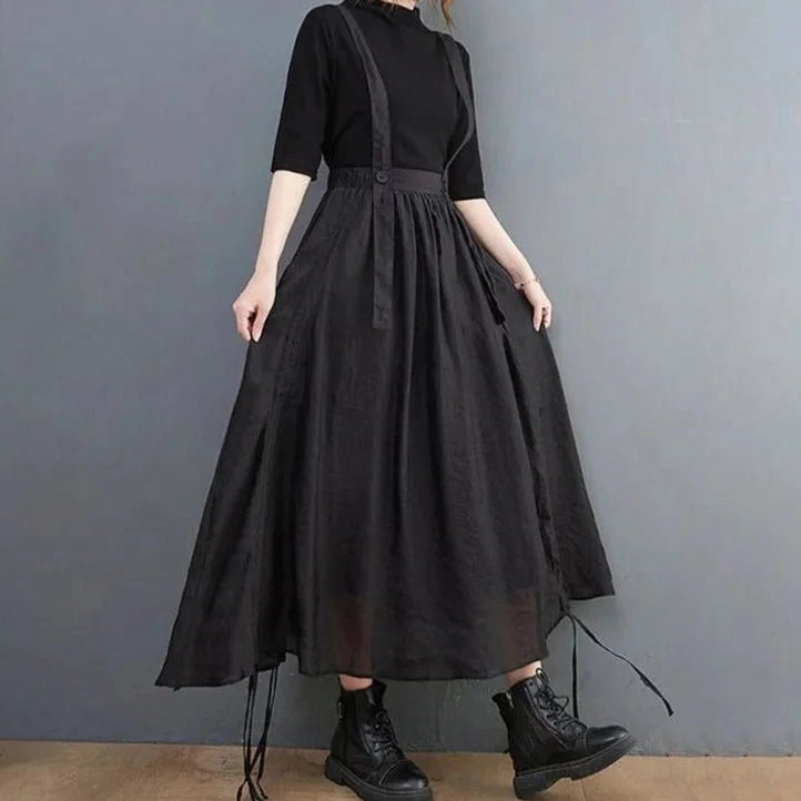 Black steampunk suspender skirt front three-quarter view with adjustable straps and asymmetric hem detail