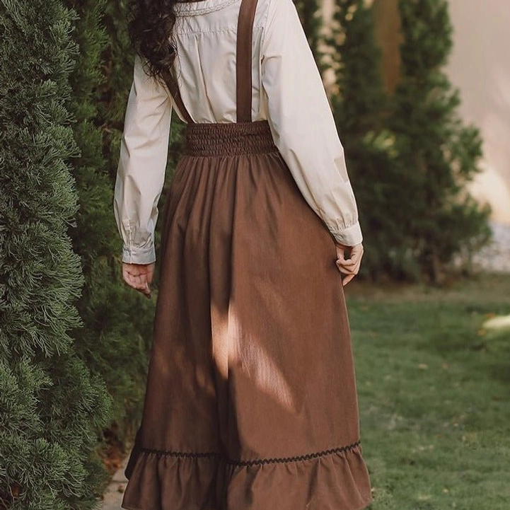 Rear view of steampunk suspender skirt showing shirred elastic waist construction and ruffled brown corduroy hem