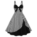 Victorian steampunk swing dress with black and white vertical stripes, asymmetric black hem, and decorative black fabric bow at bust, front three-quarter view on white background