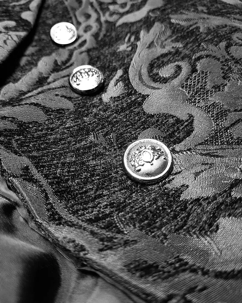 Close-up detail of grey jacquard texture and round silver metal buttons on steampunk tailcoat
