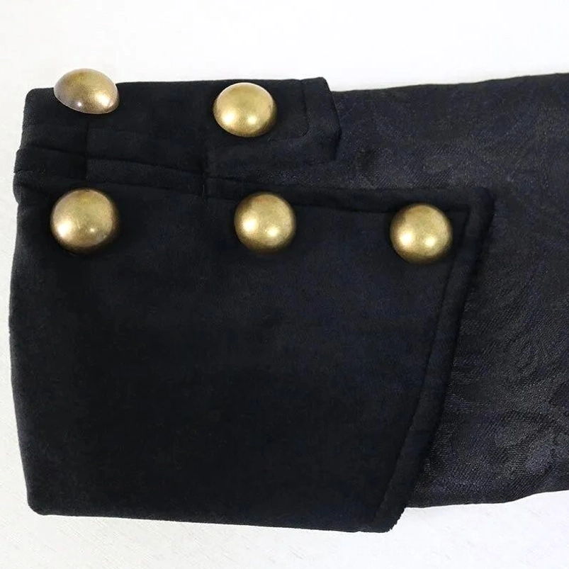 Steampunk jacket cuff detail showing matte gold dome button and black velvet trim close-up