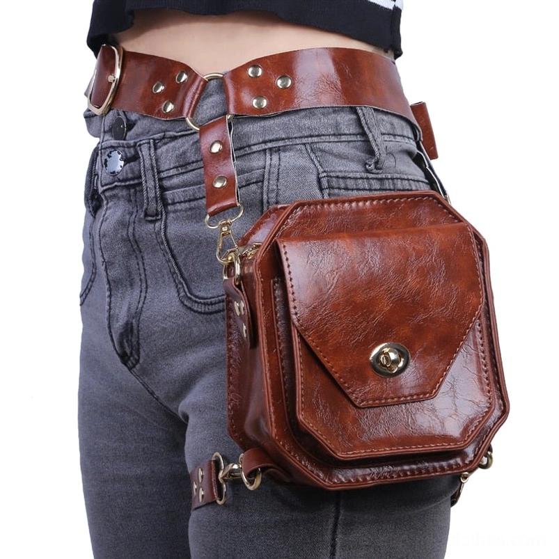 Steampunk leather thigh bag attached to gray denim jeans at waist, side profile view showcasing twist-lock mechanism and premium brown faux leather construction details