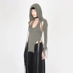 Steampunk three-piece cutout knit top set - hooded base component in olive grey with side cutouts and integrated drawstring hood, modeled on East Asian female in full-body front view against white studio background