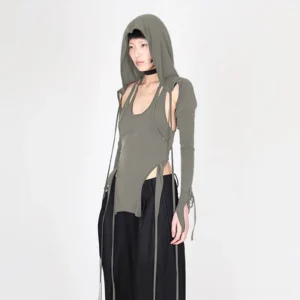Steampunk three-piece cutout knit top set - hooded base component in olive grey with side cutouts and integrated drawstring hood, modeled on East Asian female in full-body front view against white studio background