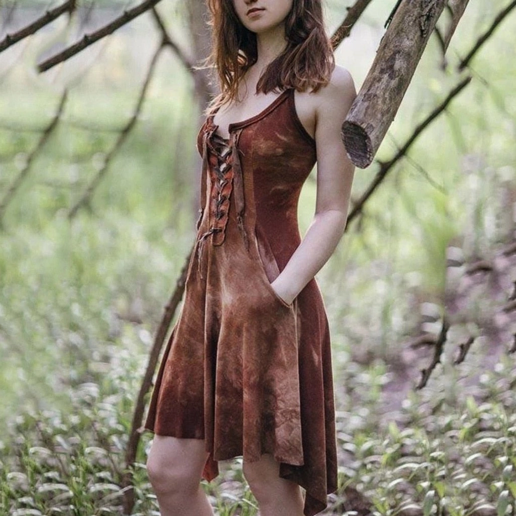 Brown tie-dye steampunk camisole dress with lace-up front detail, high-low asymmetrical hem, and side pockets on model in outdoor woodland setting