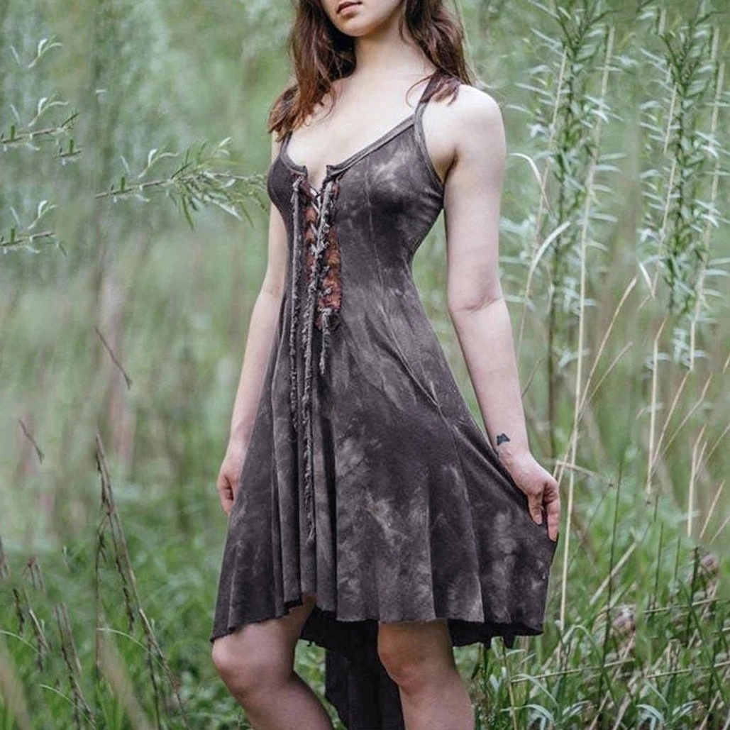 Charcoal gray tie-dye steampunk camisole dress with lace-up corset front, irregular hem, and functional pockets on model in wetland setting