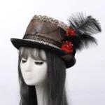 Victorian steampunk top hat with gears and chains, modeled on female mannequin with gray wig, featuring brown distressed fabric, red flowers, black feather and antique metal decorations