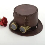 Vintage steampunk top hat with brown faux leather and detachable brass goggles, styled with rose prop
