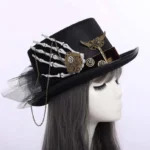 Steampunk top hat with skeleton hand embellishment worn on female mannequin, right profile view showcasing gears, chains and black mesh veil details against white background