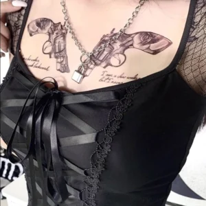 Close-up detail of satin ribbon corset lacing, rose lace trim, and scalloped edge on gothic steampunk top