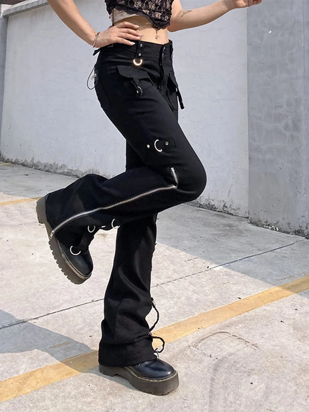 Steampunk cargo pants side profile showing metal eyelet lacing system, side zippers, and industrial hardware - gothic alternative fashion trousers