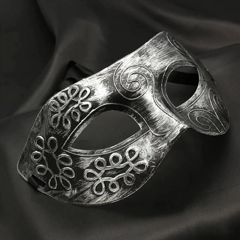Distressed silver steampunk Venetian masquerade mask with embossed scroll and floral motifs, shown from oblique side angle on dark backdrop