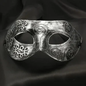 Symmetrical antique silver steampunk Venetian mask with carved scrollwork and clover patterns, front view showcasing detailed craftsmanship
