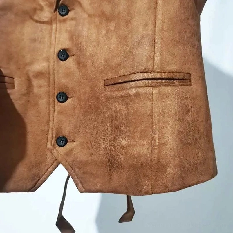 Close-up detail of brown suede steampunk vest front showing black round buttons, welt pockets, and pointed hem design