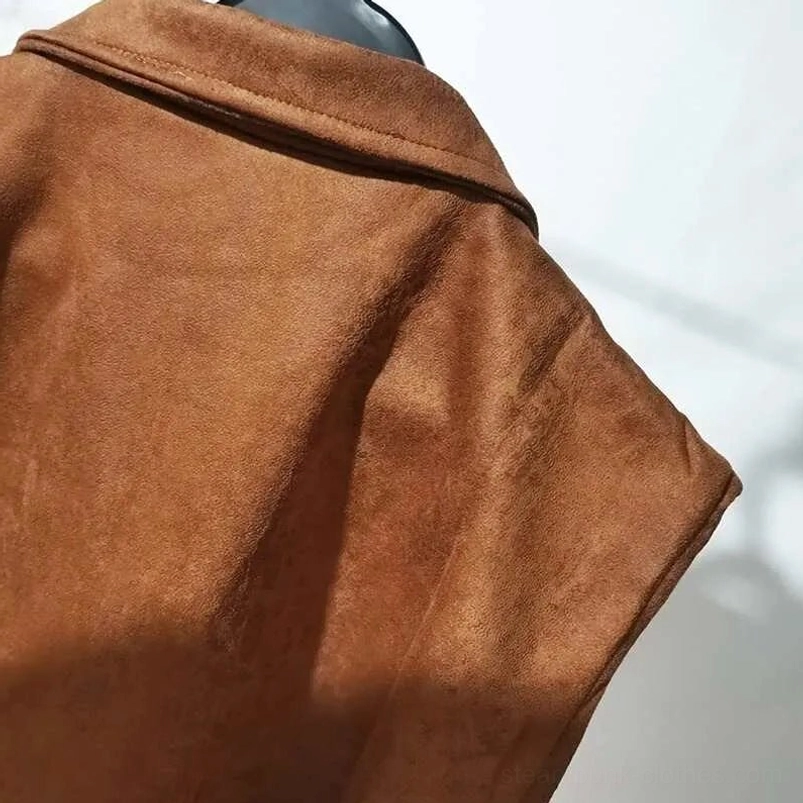 Close-up of brown suede steampunk vest lapel and shoulder seaming detail showing stitched craftsmanship and neat tailoring