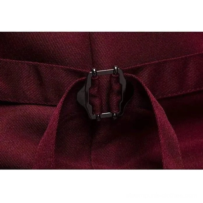 Close-up detail of metal buckle and adjustable back belt on wine red twill waistcoat fabric