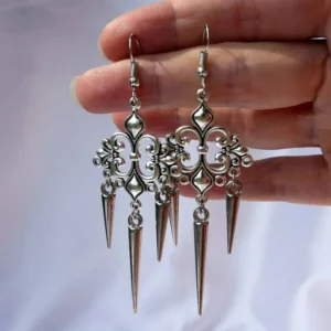 Steampunk Victorian filigree chandelier drop earrings with antique silver tone and dangling spike pendants, paired set displayed on white fabric background