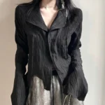 Black steampunk Victorian gothic shirt with notched collar, crinkled fabric texture, and single button front closure - front view detail