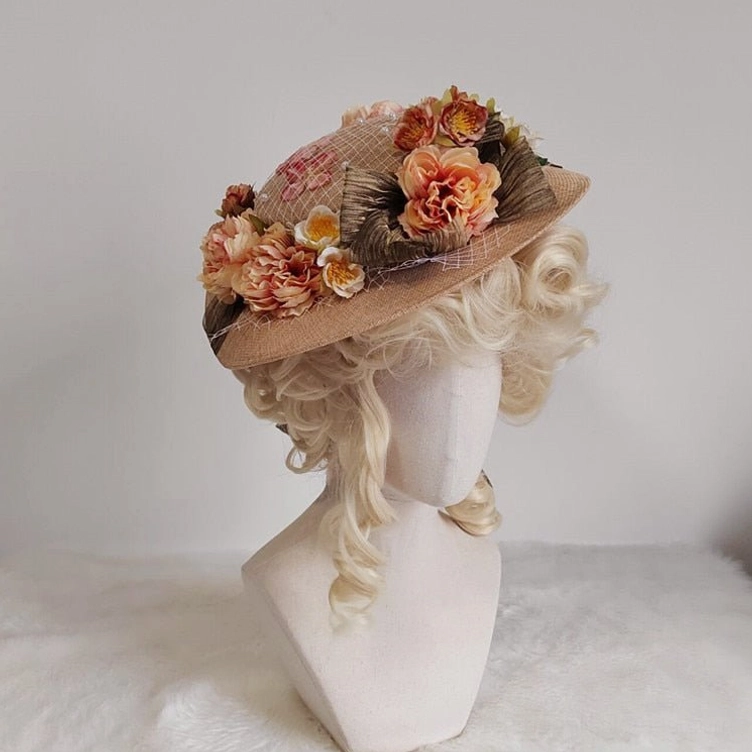 Steampunk Victorian wide-brimmed floral hat with woven straw texture and pleated brown trim, displayed on mannequin with blonde curly wig, left side view on white plush tabletop